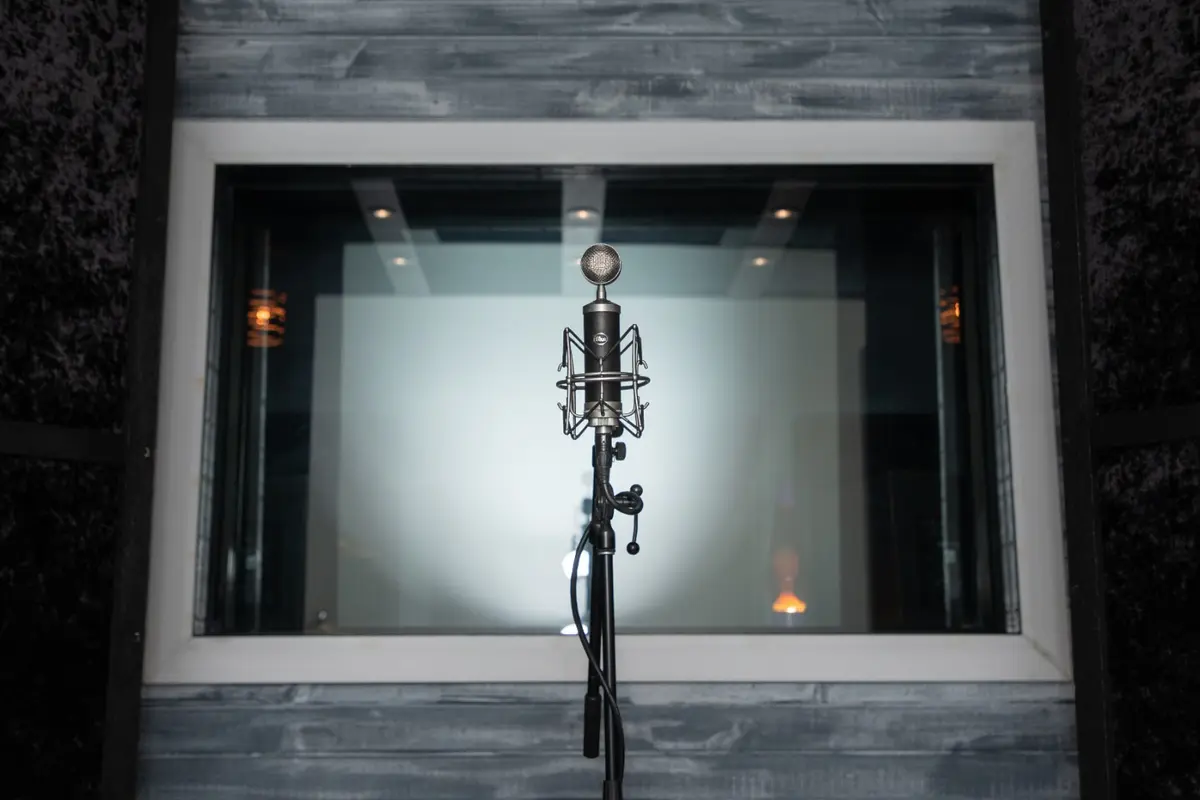 Studio microphone positioned in front of the live room window